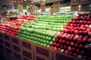 large apple display stand at a grocery store